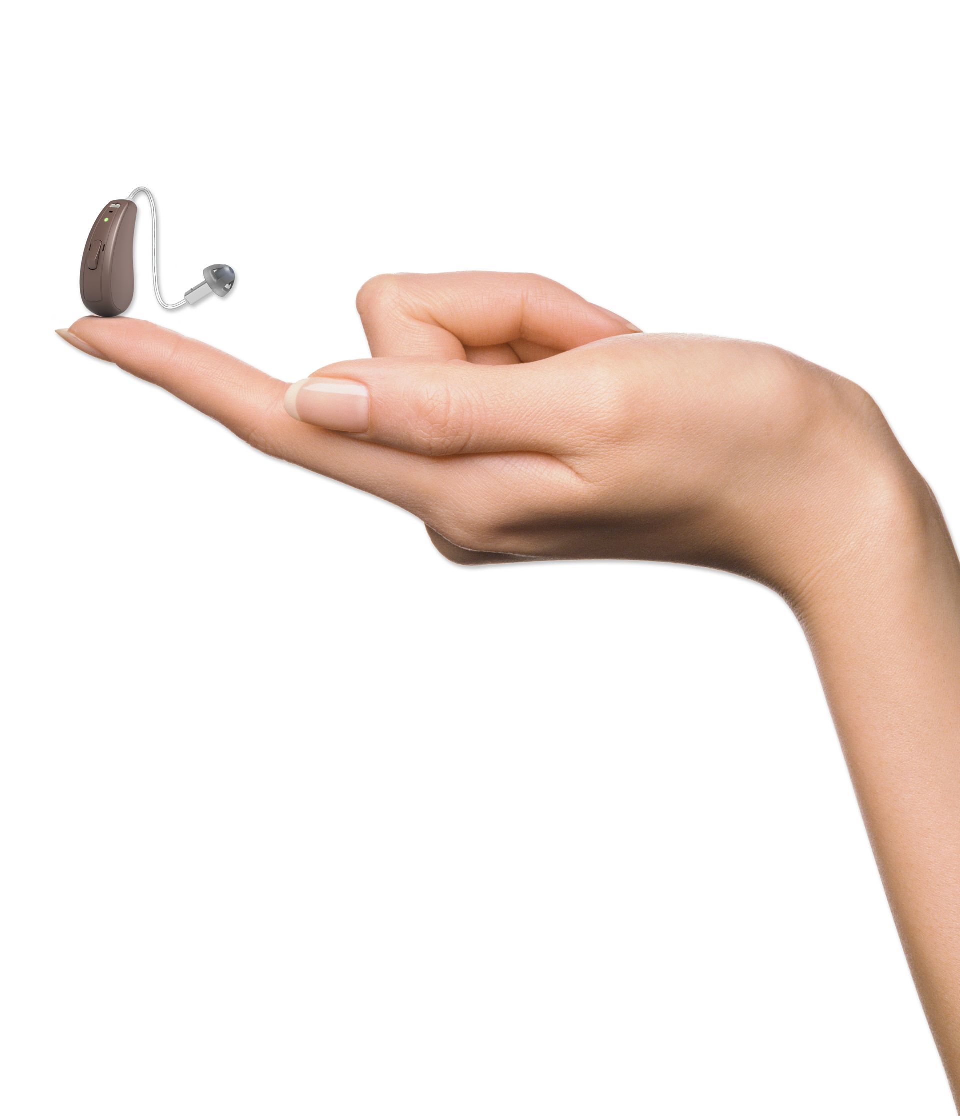 A Woman is Holding a Hearing Aid in Her Hands — Clayton Hearing in Pialba, QLD