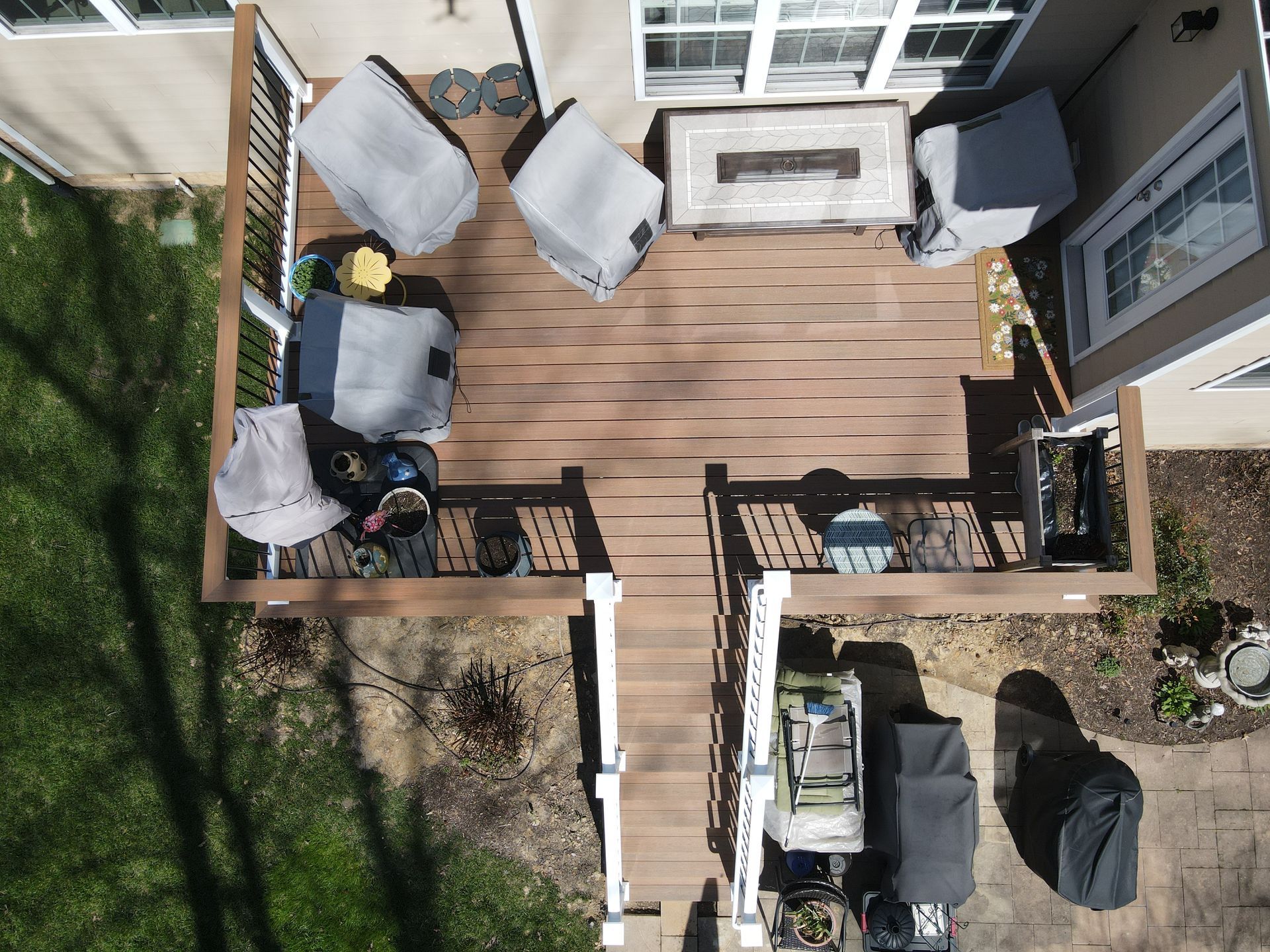 Overhead view of a wooden deck with patio furniture and outdoor seating area.
