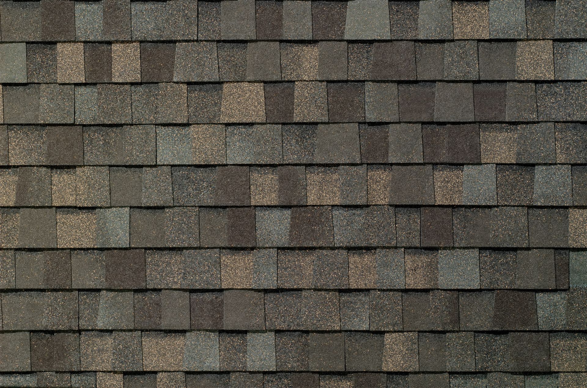 Dark brown asphalt roof shingles arranged in horizontal rows.