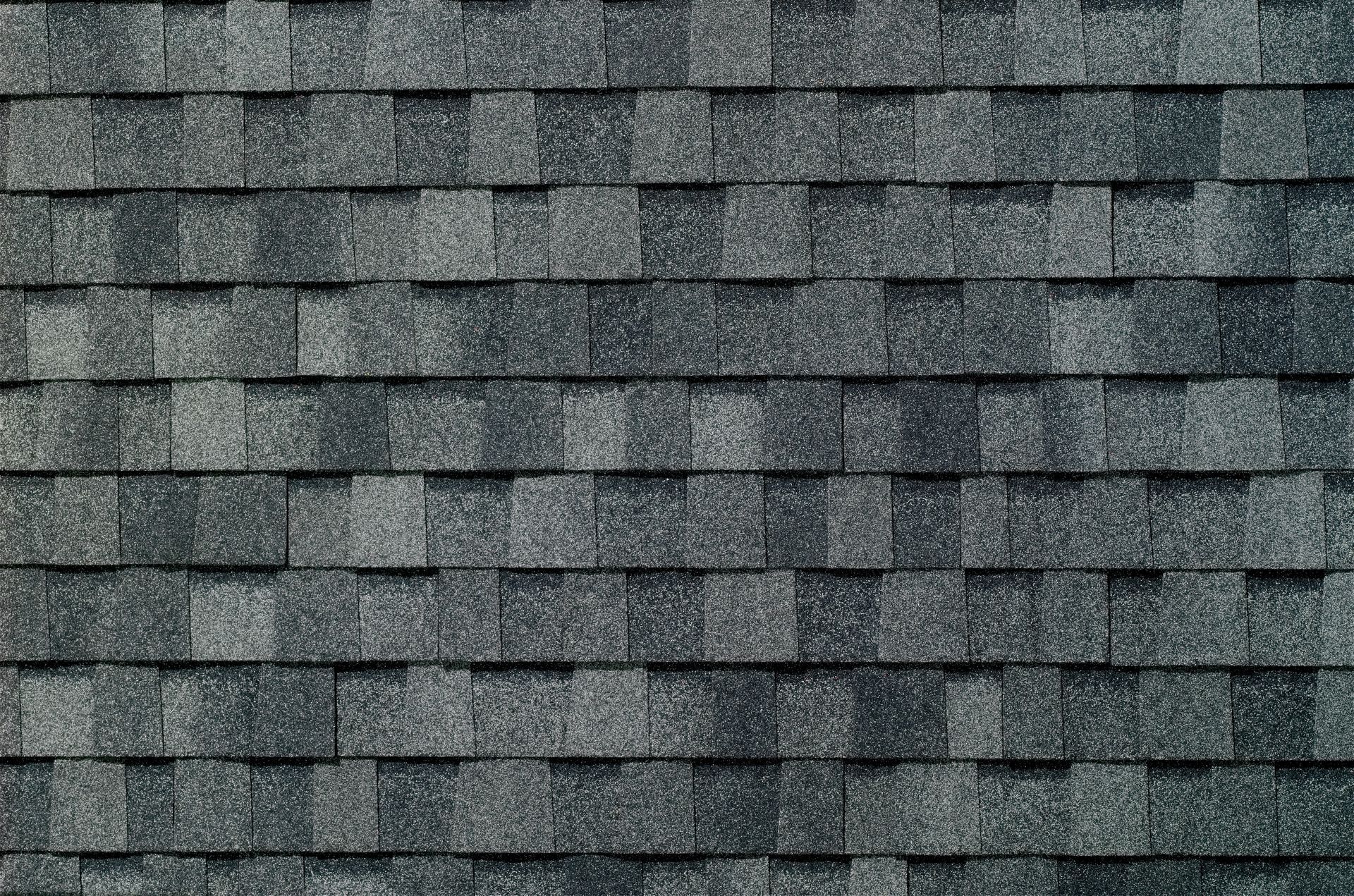 Gray asphalt shingle roof texture with horizontal rows