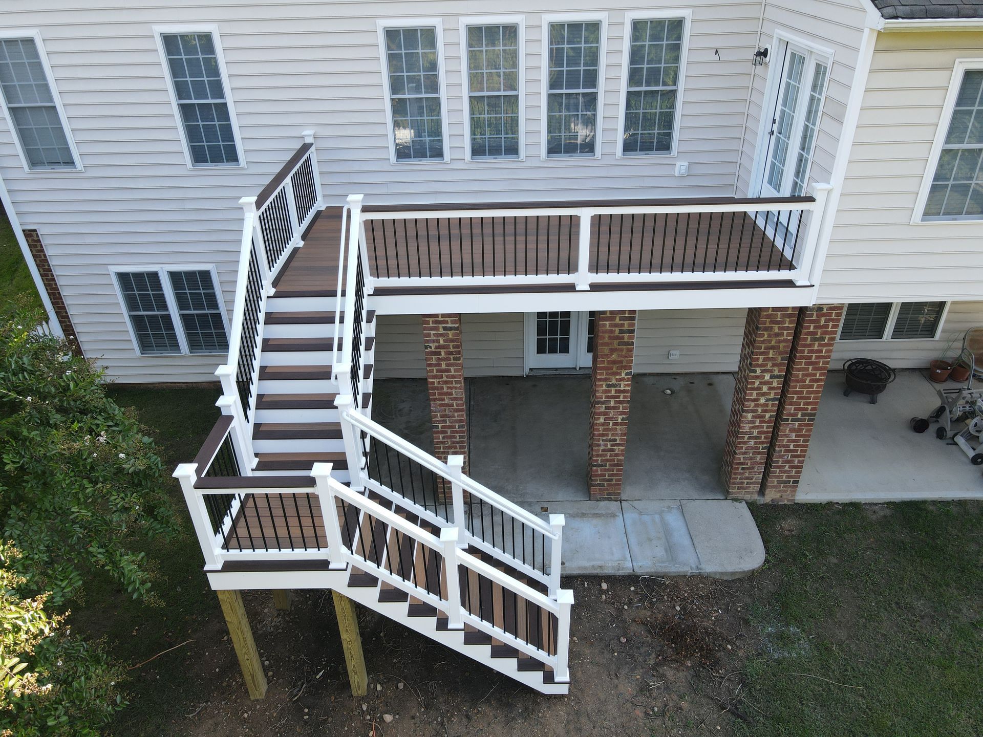 House exterior with elevated deck and white wooden ramp beside stairs