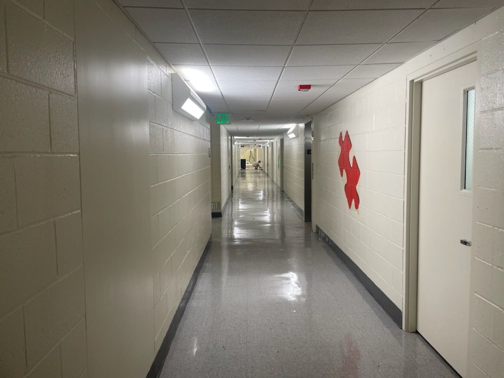 A long hallway with a red puzzle piece on the wall.