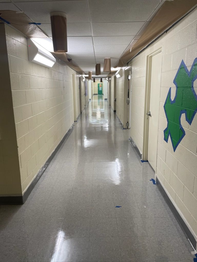 A long hallway with a puzzle piece on the wall.