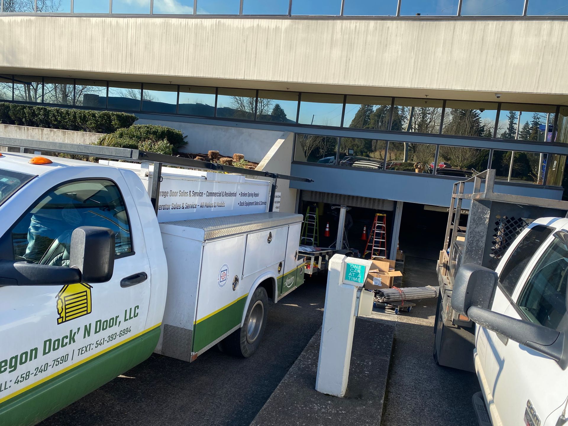 White service truck parked near building, Oregon Door & Gate LLC logo visible.