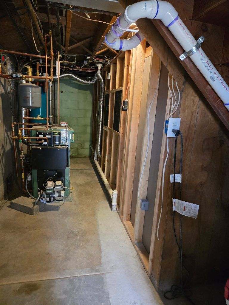 Basement utility room with water heater, furnace, exposed pipes, and ductwork along unfinished walls