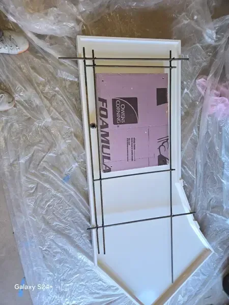 Pink “FAMILY” sign in a white frame, wrapped in plastic packaging