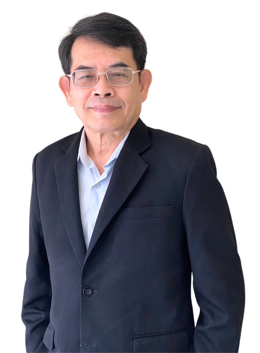 A man in a suit and glasses is standing with his hands in his pockets.