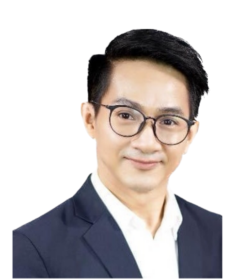 A man wearing glasses and a suit is smiling for the camera.