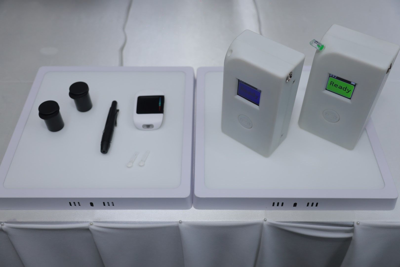 Two white boxes are sitting on top of a white table