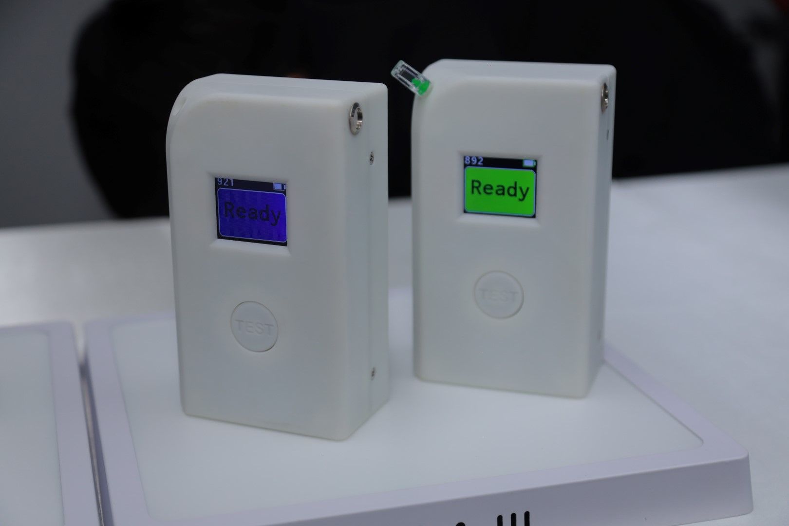 Two white boxes with a green screen that says ready