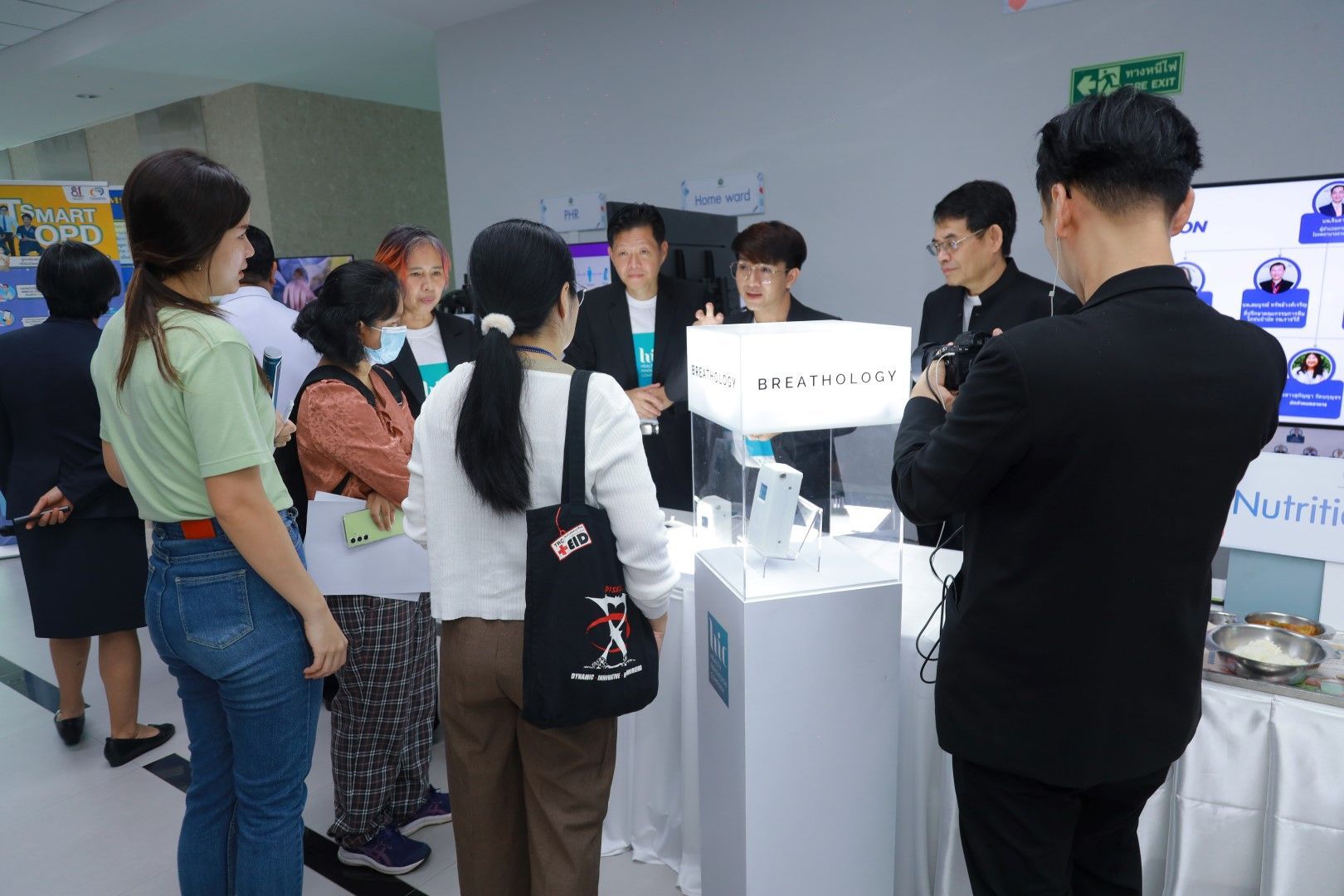 A group of people are standing around a table in a room.