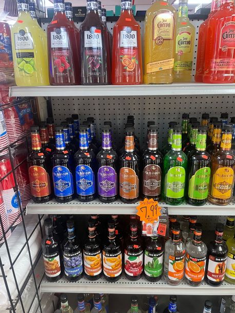 Bottles of Sutter Home Wine Are Lined up On a Shelf