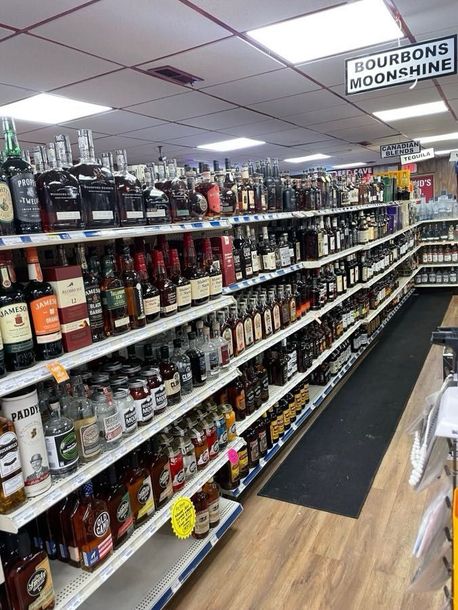 A liquor store filled with lots of bottles of alcohol on shelves.