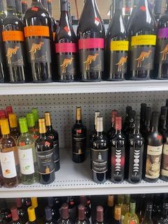 Two Bottles of Red Wine and A Glass of Red Wine