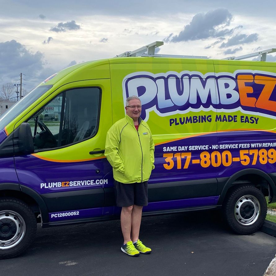 Person standing beside a purple-and-lime PlumbEZ plumbing van with company logo and phone number.