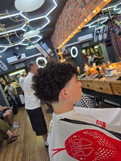 A man is getting his hair cut at a barber shop