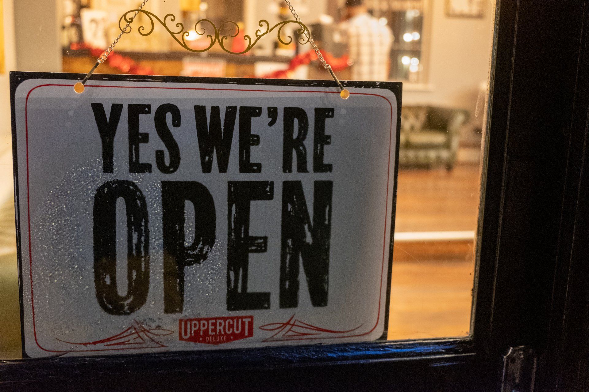 A sign in a window that says `` yes we 're open ''.