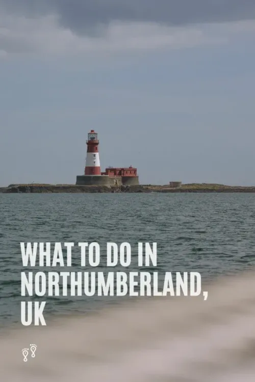 Lighthouse on a rocky shore under cloudy sky, with text: “What to do in Northumberland, UK”