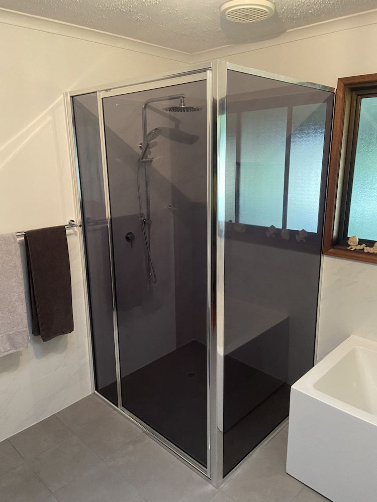 A Bathroom With A Shower Stall And A Bathtub — Browny's Glass & Aluminium in Wingham, NSW