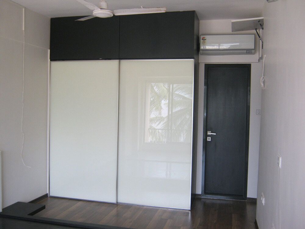 A Bedroom With Sliding Glass Doors And A Black Door — Browny's Glass & Aluminium in Wingham, NSW
