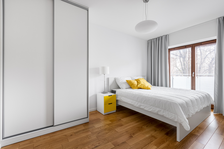 A Wooden Wardrobe With A Sliding Door And Drawers — Browny's Glass & Aluminium in Wingham, NSW