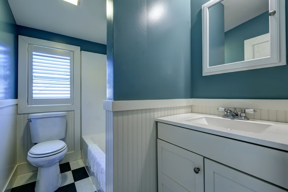 A Bathroom With A Toilet, Sink, And Mirror — Browny's Glass & Aluminium in Wingham, NSW