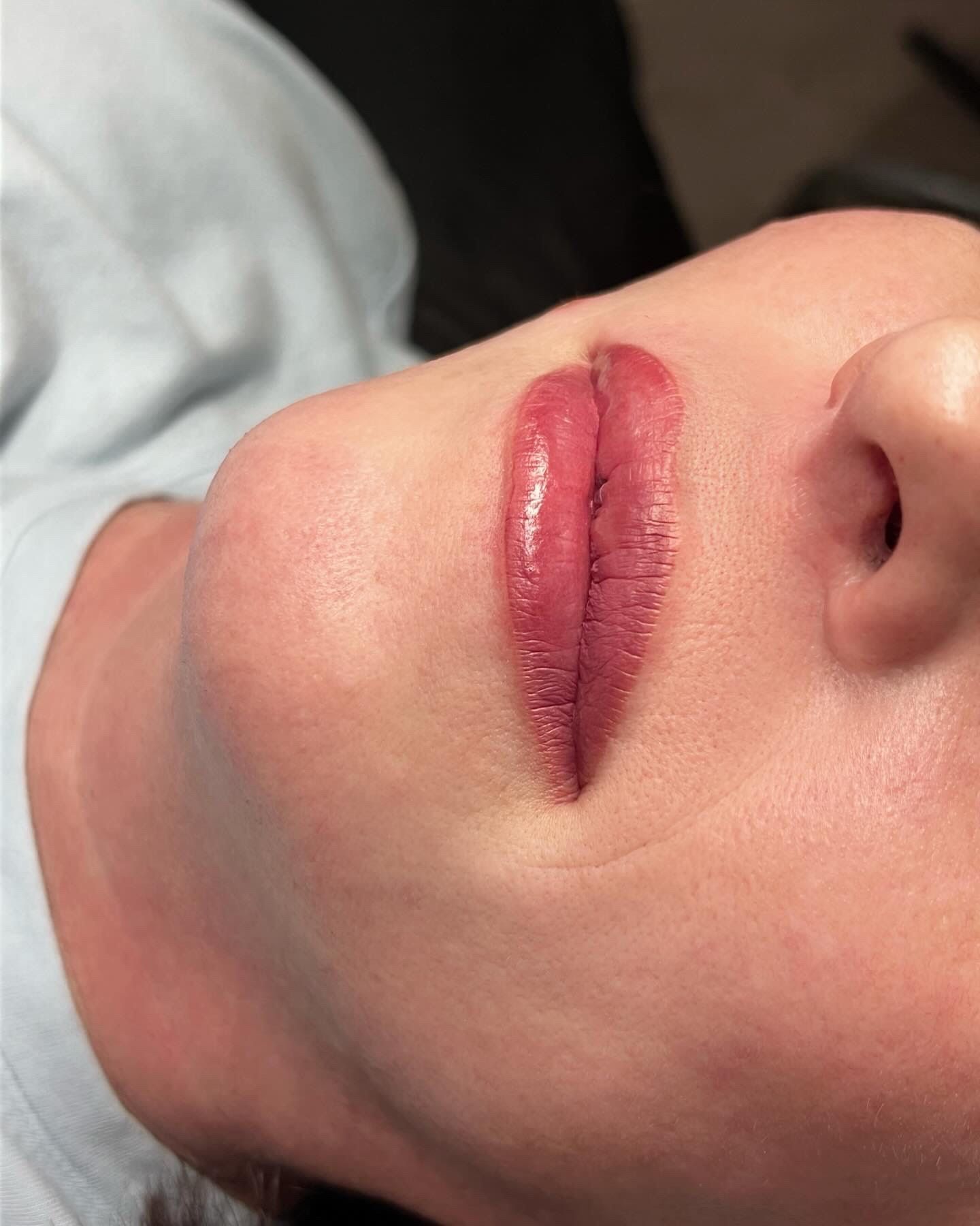 A close up of a woman 's lips with red lipstick.