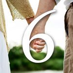 A man and a woman are holding hands in front of a number six.