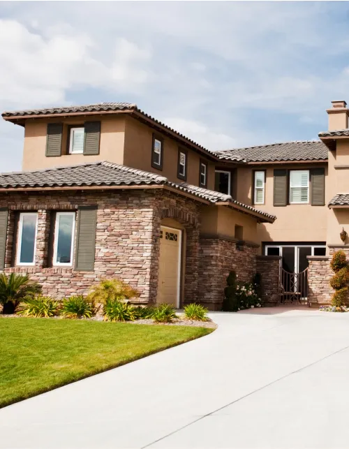 A large house with a lot of windows and a driveway