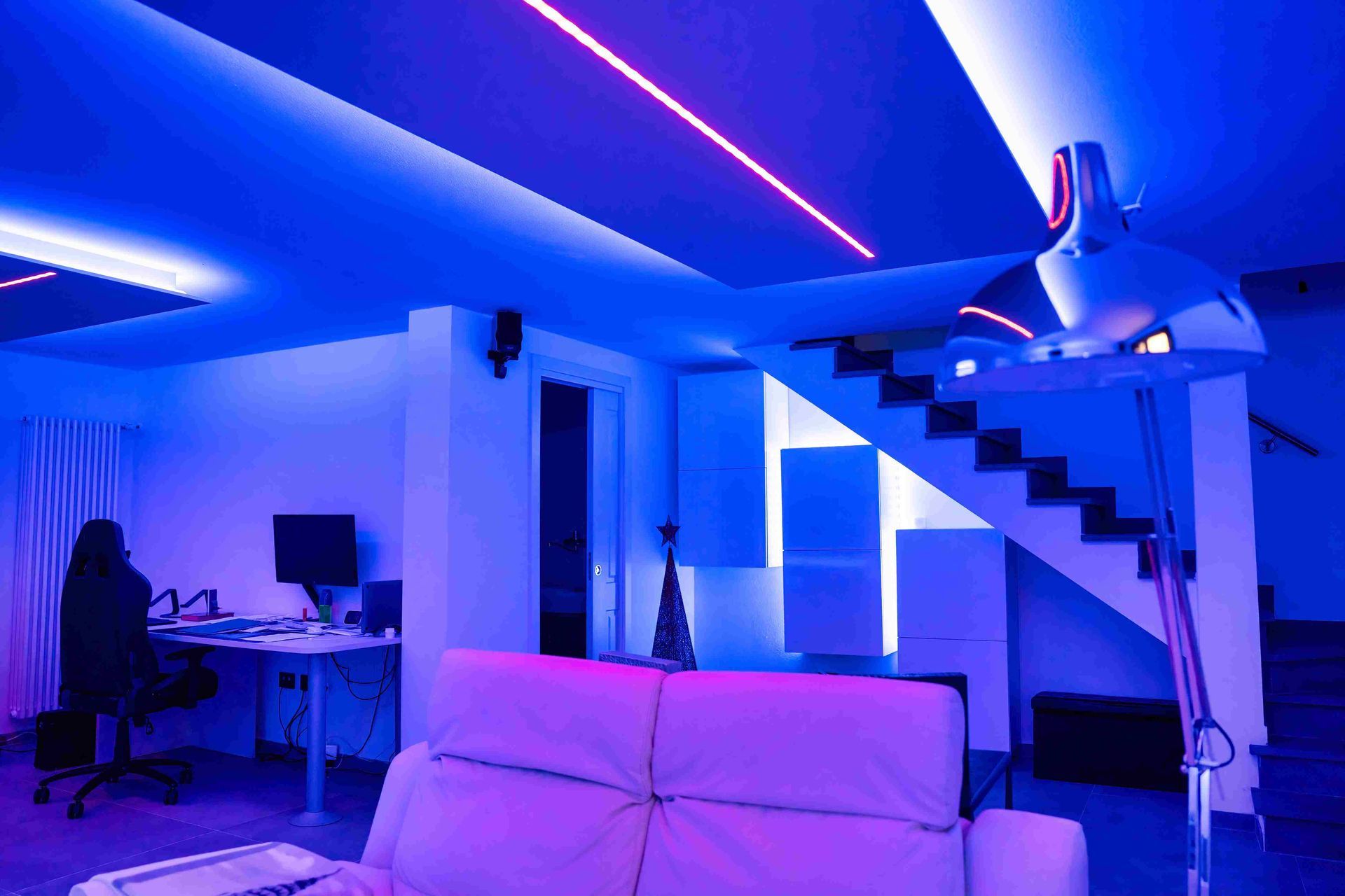 a finished basement with neon lighting