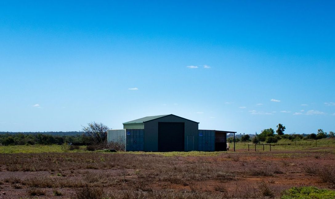 A Shed In The Middle Of A Field With A Blue Sky In The Background — Tinman's Welding Worx In Moranbah, QLD