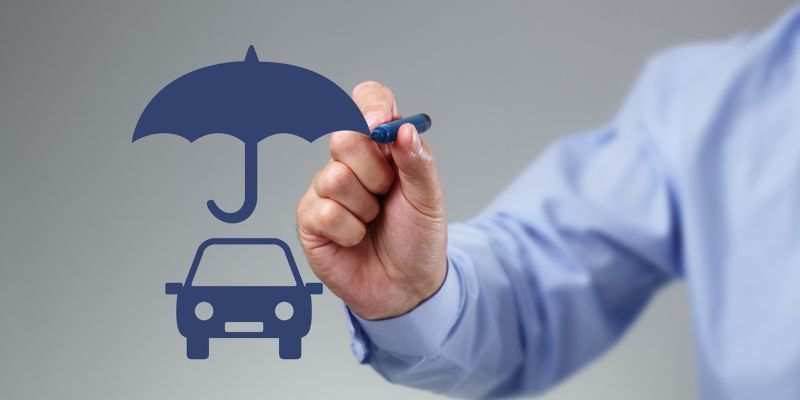 A man is drawing an umbrella over a car with a marker.