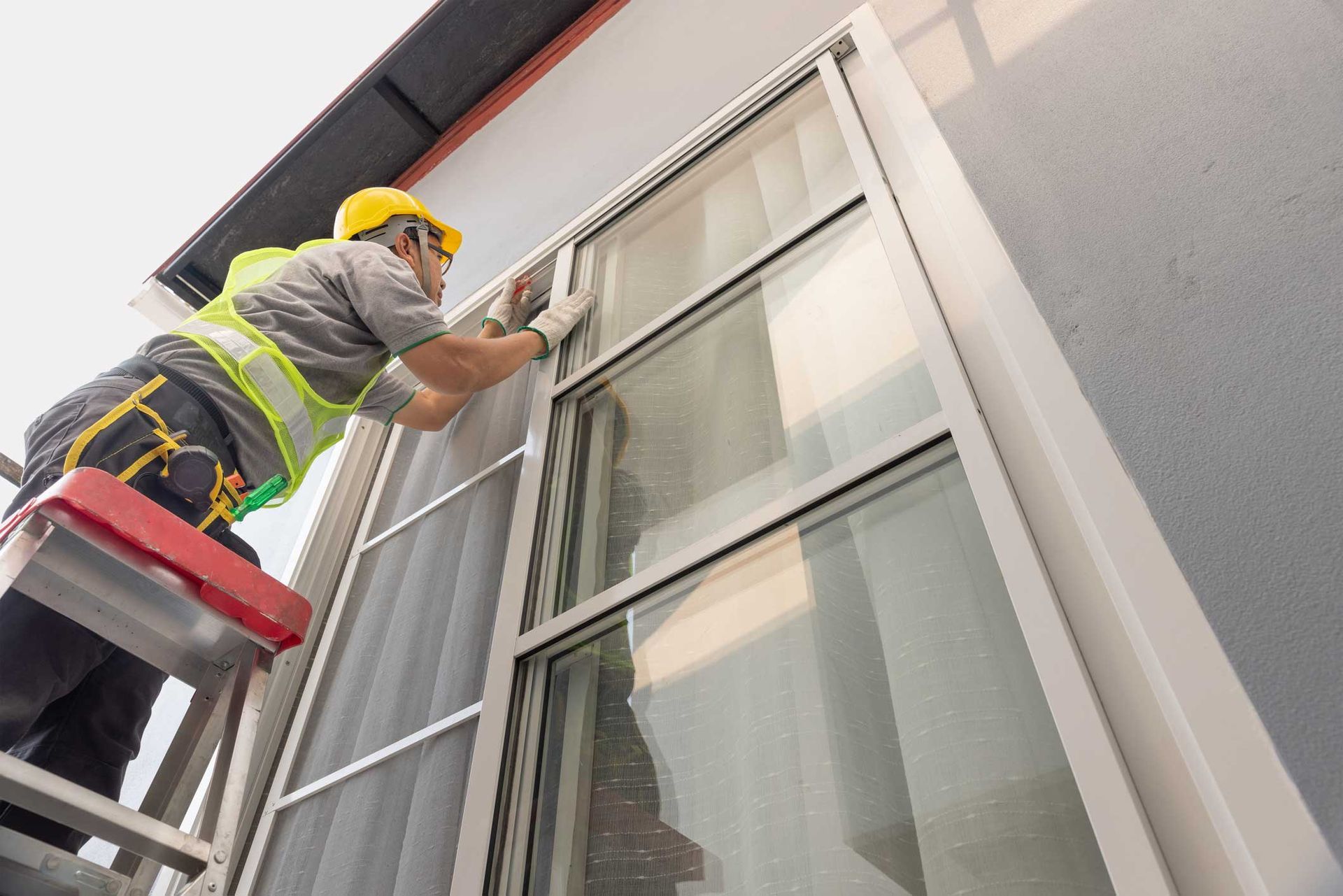 Construction Worker Repairing The Sliding Window — Powder Springs, GA — R.D. Dunn Aluminum Products Construction Worker Repairing The Sliding Window — Powder Springs, GA — R.D. Dunn Aluminum Products