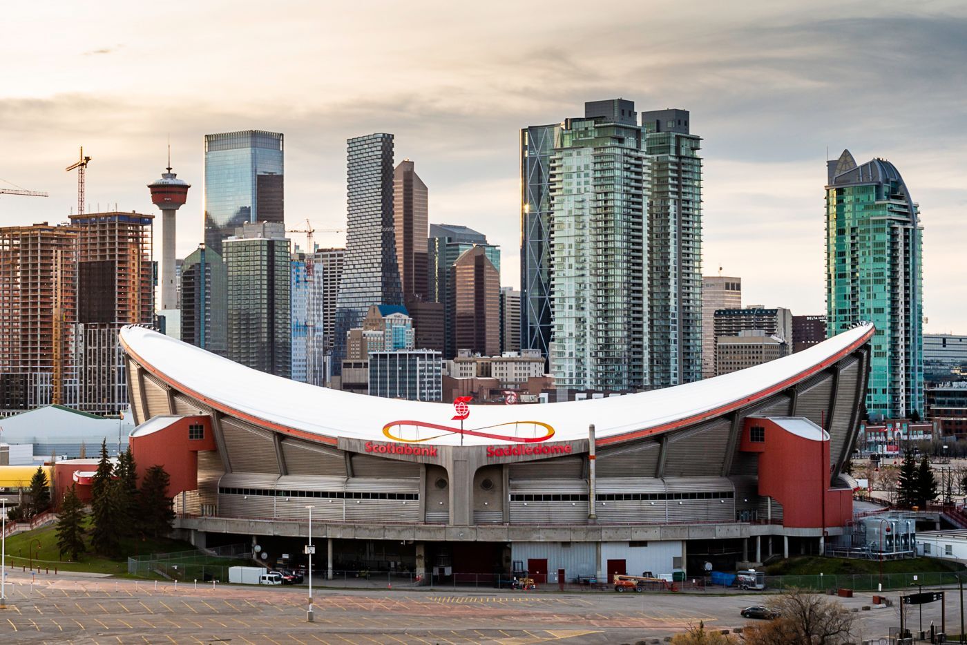 Calgary Saddledome with downtown skyline at sunset behind it