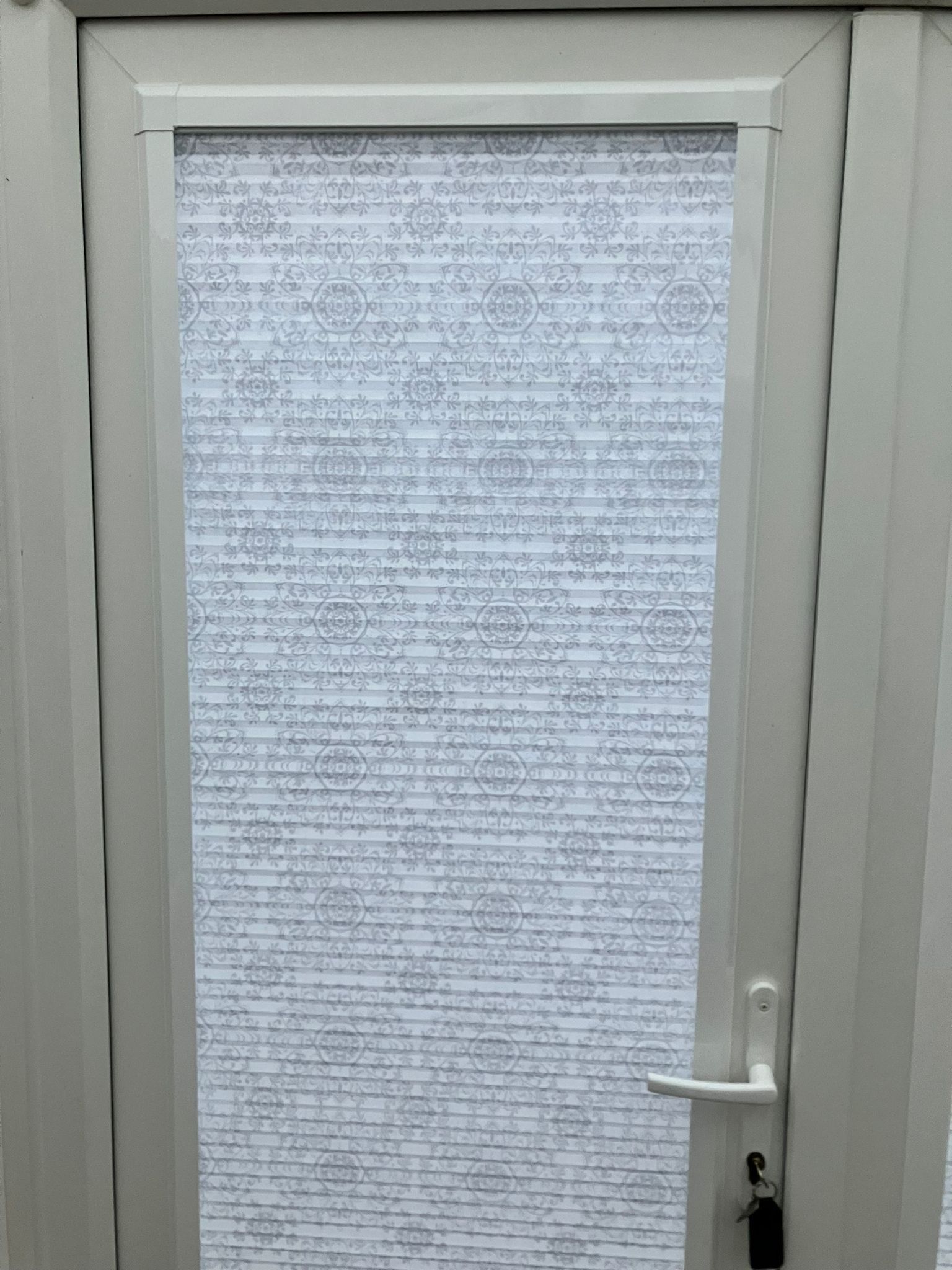 White door with opaque glass, a handle, and a key lock.