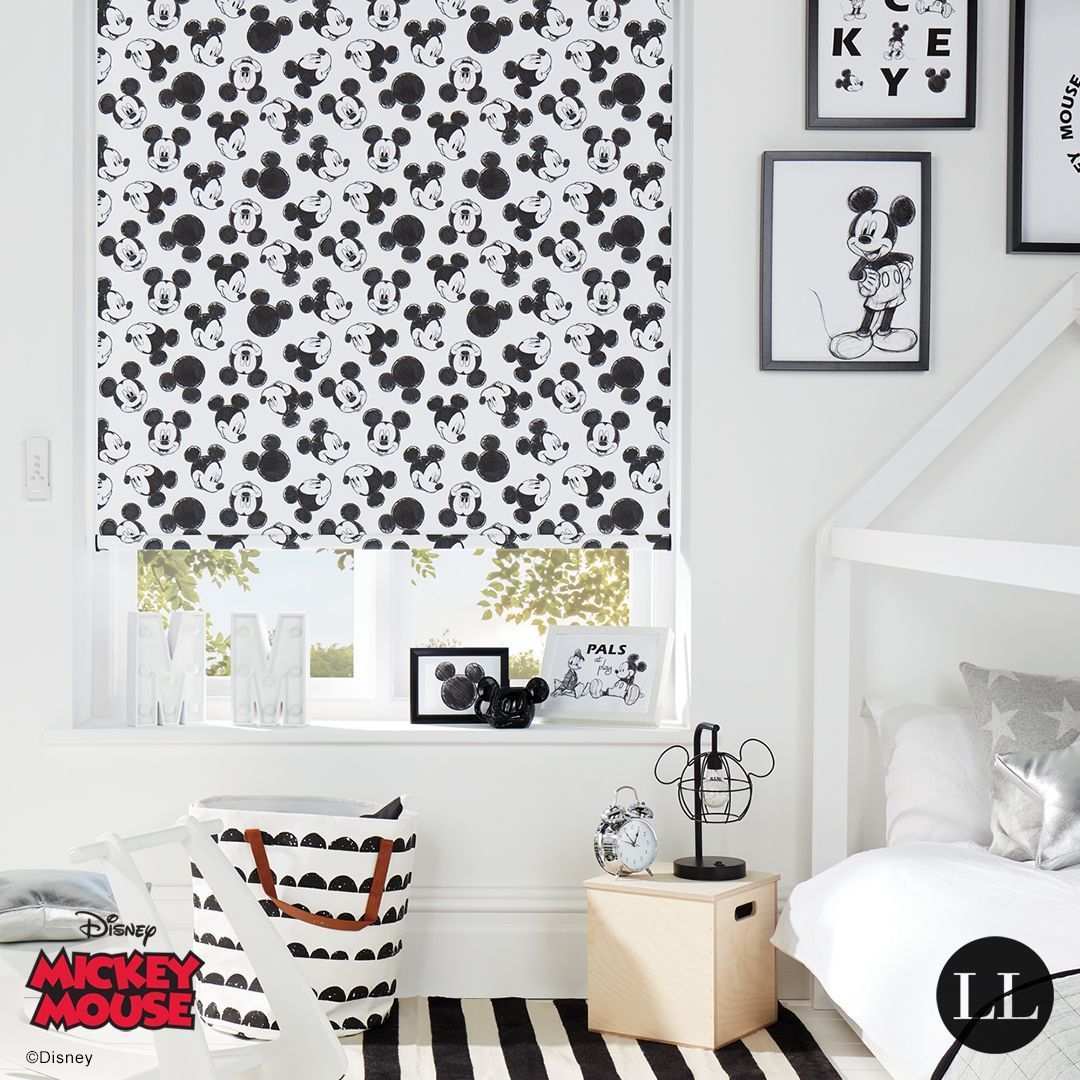 White room with Mickey Mouse pattern blind, black and white decor.