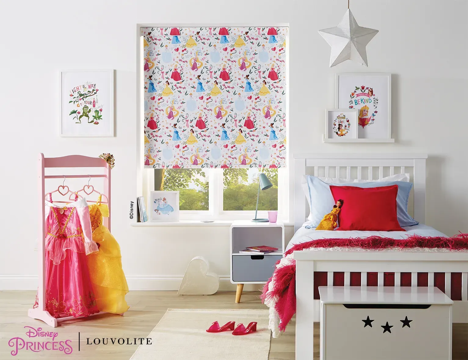 A child's bedroom with Disney Princess themed decor, including a window blind, framed art, and costumes.