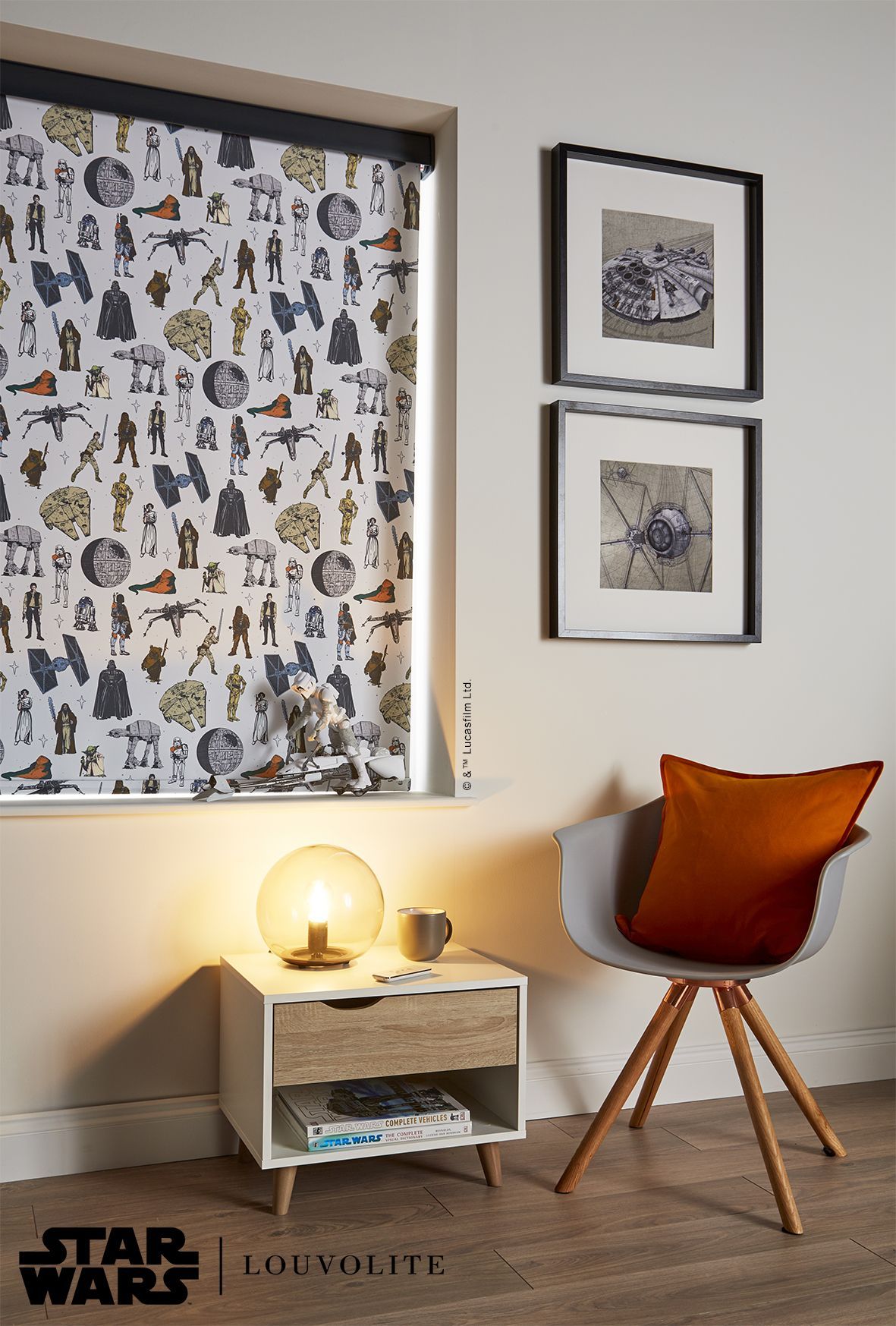 Star Wars-themed window blind, bedside table with lamp, chair, and framed art against a light-colored wall.