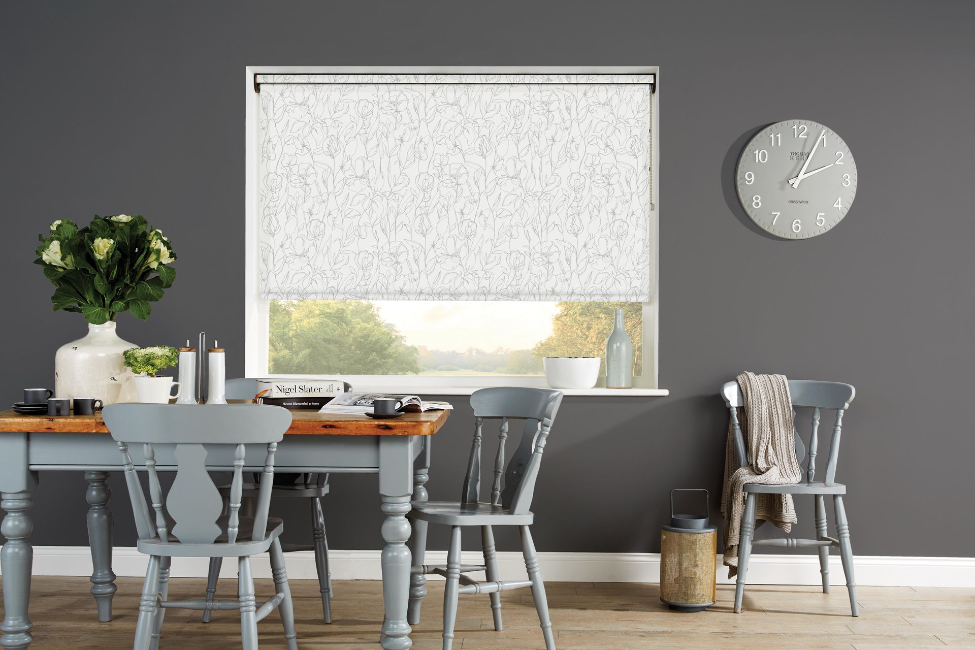 Dining room with a table, chairs, window with blinds, and a wall clock.