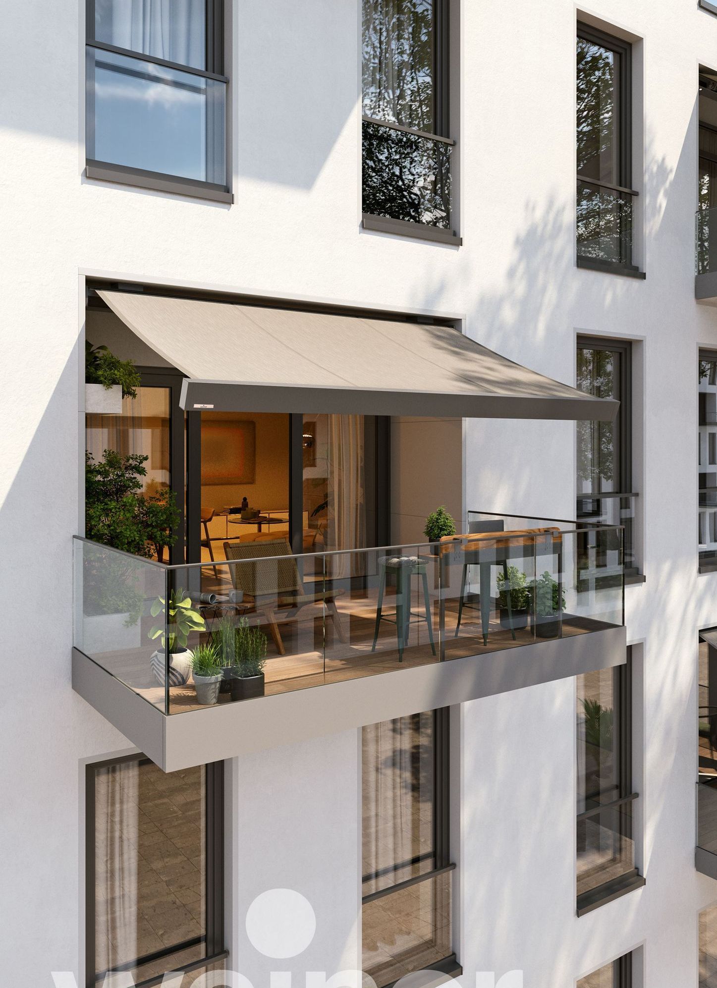 Balcony with a retractable awning, glass railing, and outdoor furniture on a white building.