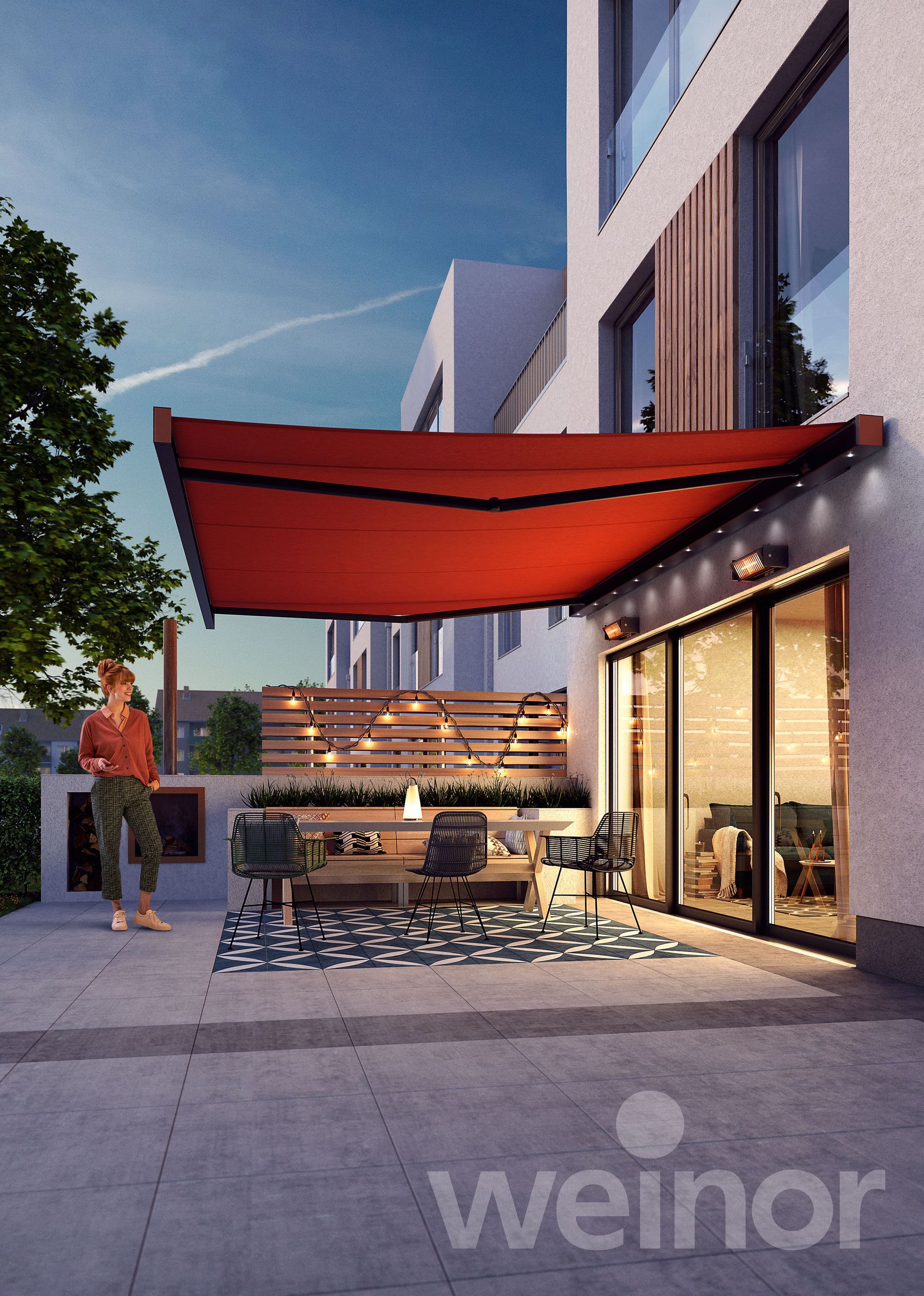Outdoor patio with red awning, person standing, seating area, and building with large windows.