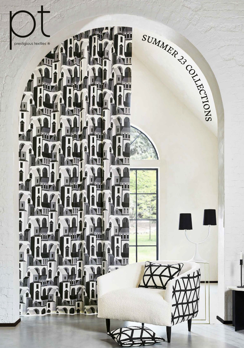 Black and white patterned curtain in an arched doorway, chair with patterned pillow, and a lamp.