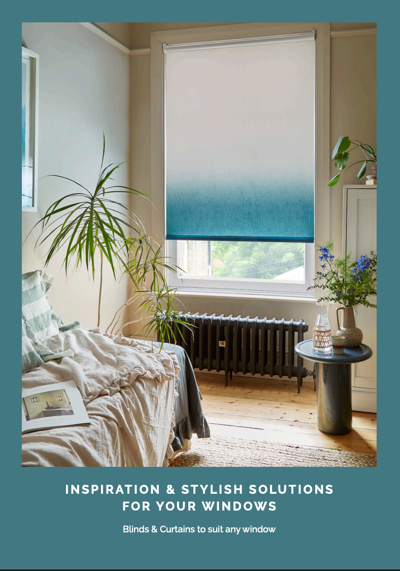 Window with teal ombre shade, bedroom interior. Bed, plants, and side table with flowers.