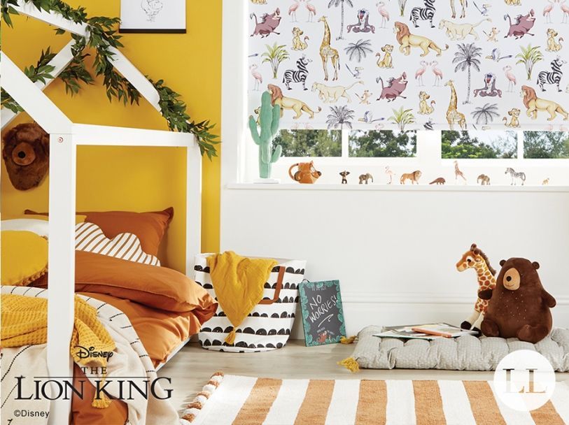 Lion King-themed nursery, featuring a bed, window with animal print blinds, and various decor items in a sunny room.