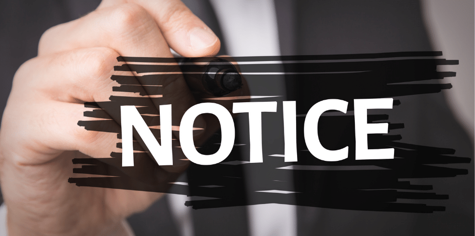 A person is writing the word notice with a marker