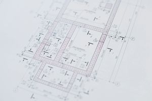 Architectural floor plan blueprint with faint pink markings on a white background