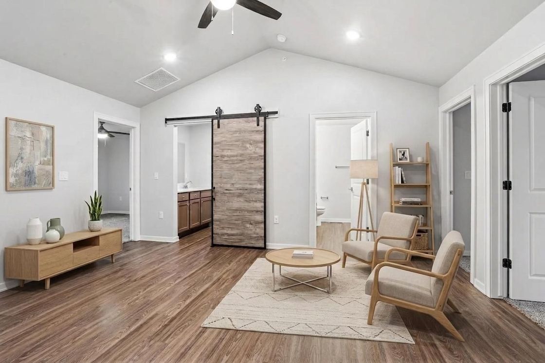 Modern kitchen with dark wood cabinets, stainless appliances, and a large marble-pattern island