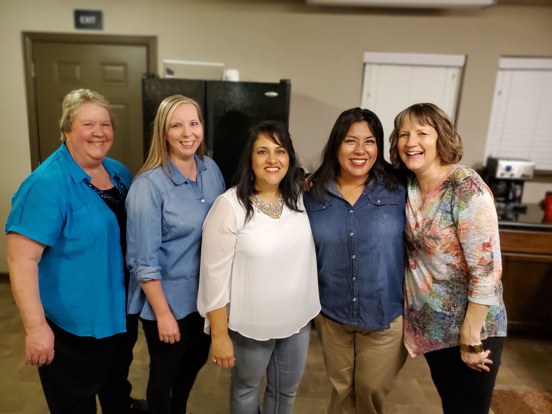 5 women standing shoulder to shoulder smiling at the camera from a citipointe church impact group meeting