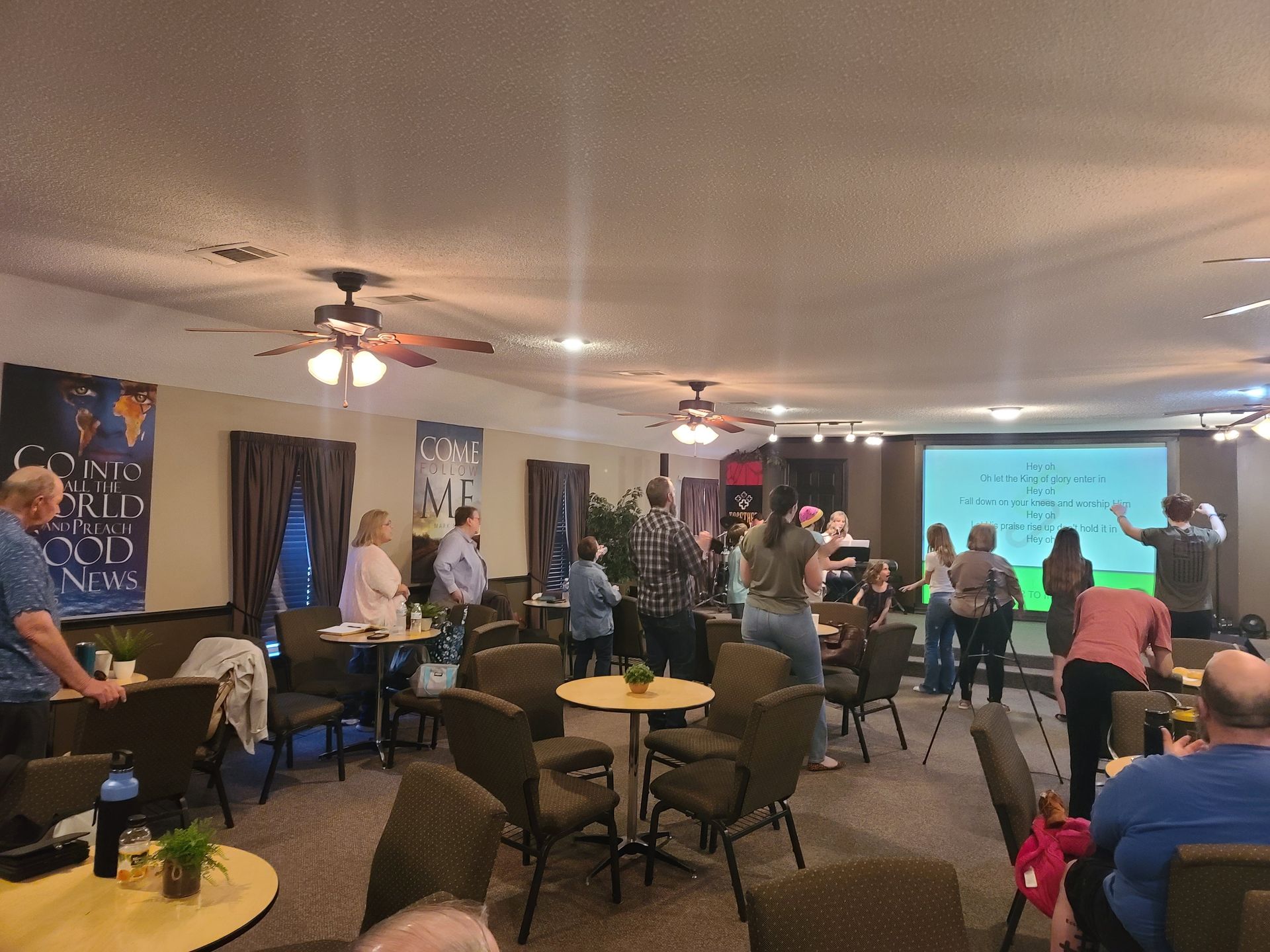 the sanctuary of citipointe church filled with the congregation singing and worshipping with hands raised