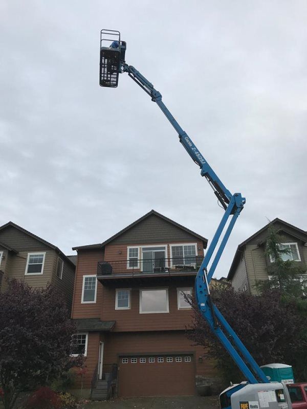 A large brick house with a crane in front of it